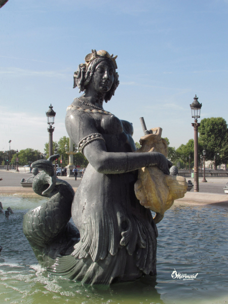 Mermaid in the fountain  at Place de la Concorde.  Photo © by Mica Moore.